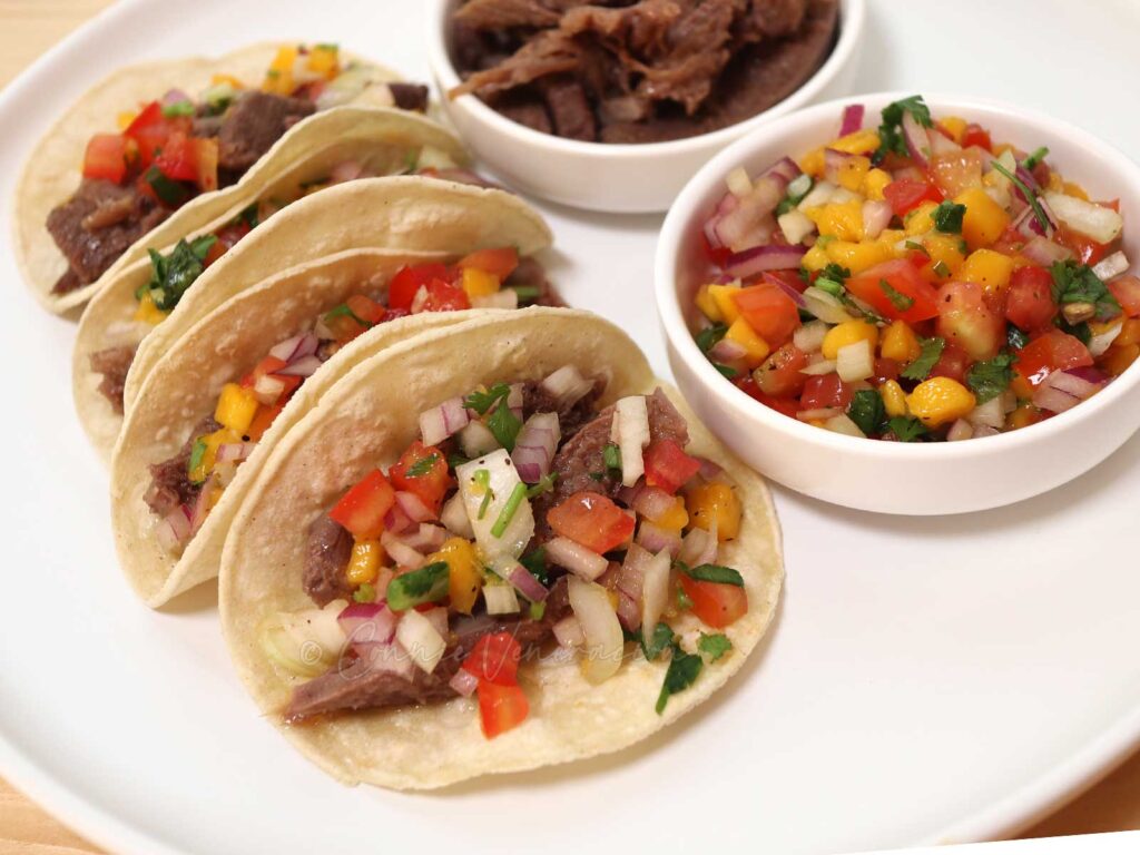 Beef (ox) tongue tacos with spicy mango salsa
