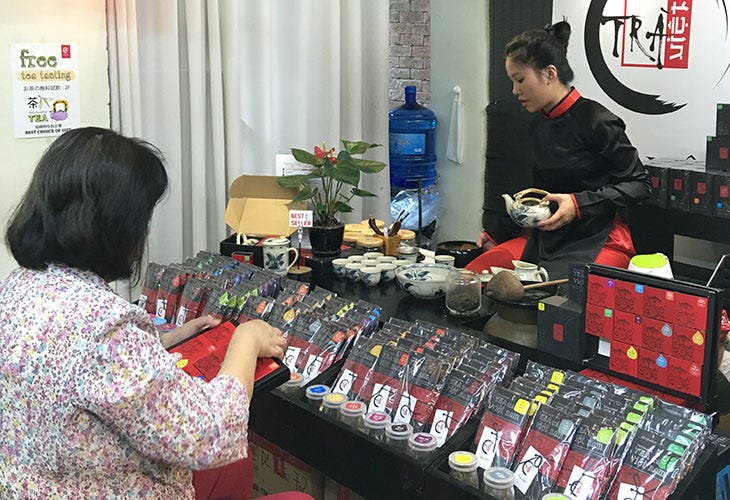 Connie Veneracion sampling tea in Ha Noi