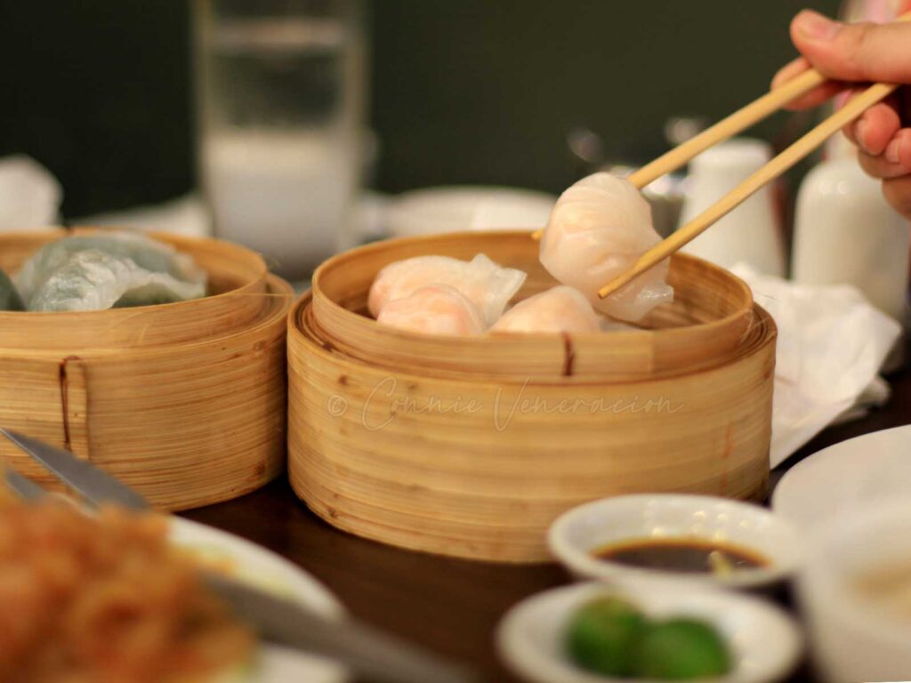 Lifting a shrimp dumpling with chopsticks